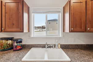Kitchen featuring dark countertops and wood finish cabinets