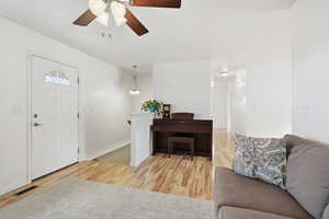 Foyer featuring light wood finished floors and a ceiling fan