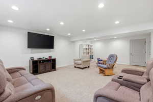 Living area with recessed lighting and light carpet