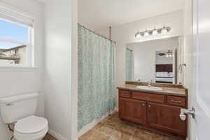 Ensuite bathroom with a shower with curtain, vanity, and ceiling fan