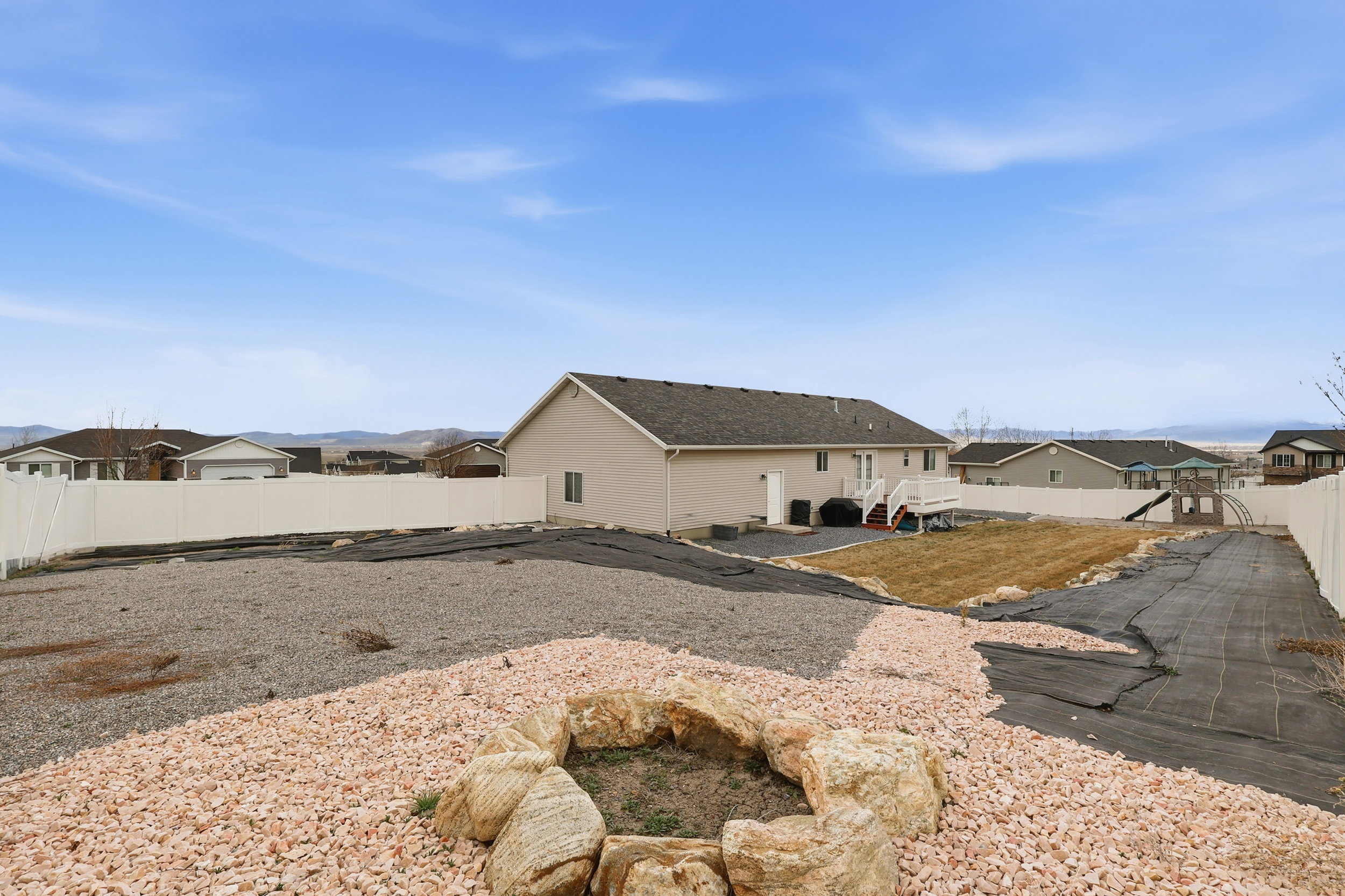 Back of house with a residential view and a fenced backyard
