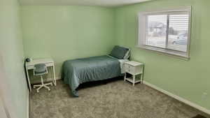Bedroom with carpet floors and baseboards