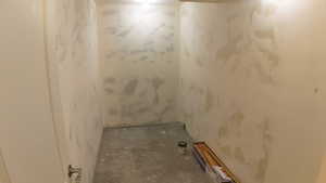 Full bath featuring concrete flooring and a shower