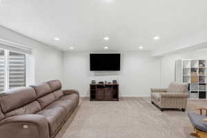 Living area featuring recessed lighting and light carpet