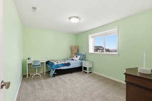 Bedroom with light carpet and baseboards