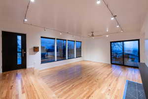 Family room featuring track lighting, ceiling fan, and 3/4 inch solid oak flooring