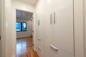 Hallway featuring custom built cabinets