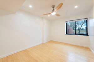Unfurnished room with light wood finished floors, a ceiling fan, and recessed lighting