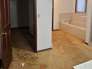 Primary Bathroom with a bath, Shower, light carpet, vanity, and ornamental molding, Big Walk In Closet