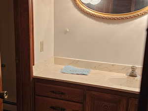 Bathroom featuring vanity, dark colored carpet, ornamental molding, and a baseboard radiator