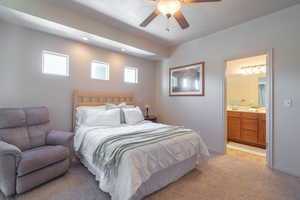 Bedroom featuring light colored carpet, a ceiling fan, ensuite bathroom, and recessed lighting