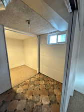 Basement featuring a textured ceiling