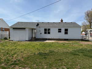 Back of house with a chimney, roof with shingles, and a patio area
