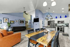 Dining room featuring lofted ceiling, ceiling fan, and light wood finished floors