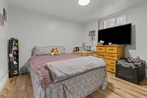 Bedroom featuring light wood-type flooring and ornamental molding