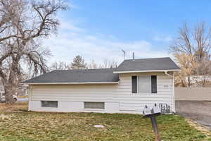 View of side of home featuring a shingled roof