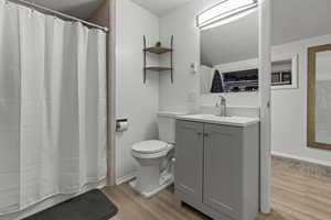 Bathroom featuring vanity, a textured ceiling, and light wood-style flooring