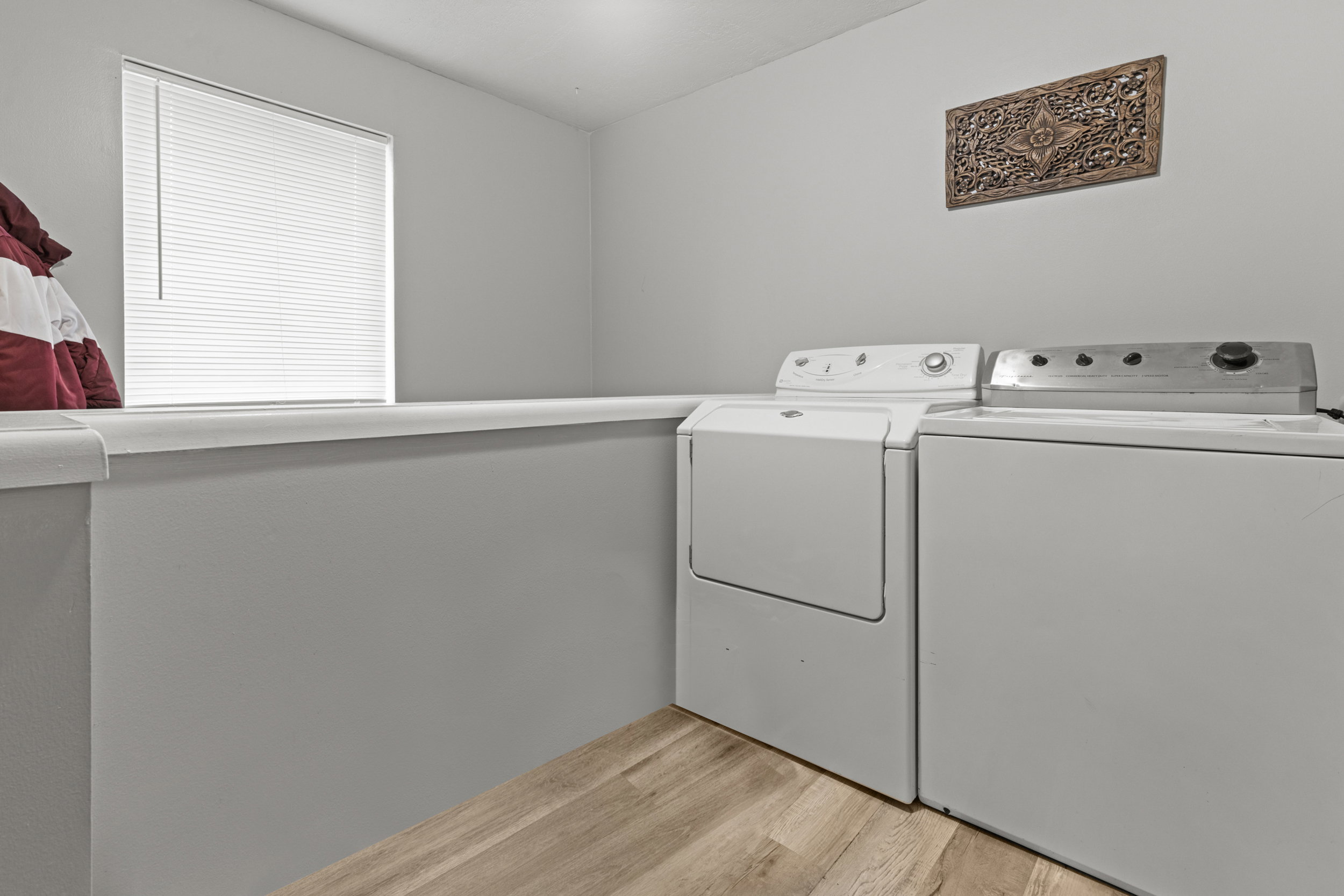 Laundry area featuring light wood-style floors and independent washer and dryer