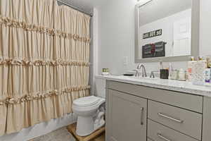 Full bath with vanity and a textured ceiling