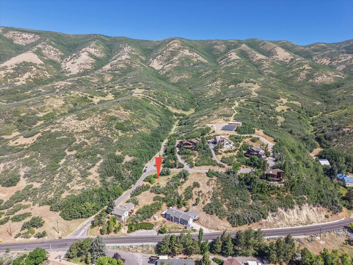 Expansive mountain landscape featuring varied terrain and a clear blue sky