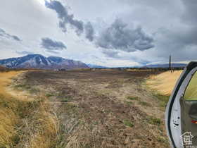 View of mountain background featuring rural landscape