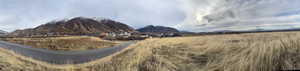 View of mountain backdrop with rural landscape