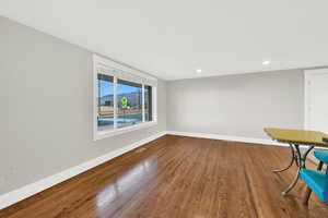 Unfurnished dining area with wood finished floors, recessed lighting, and a mountain view