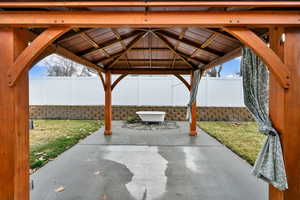 Fenced backyard with a patio and a gazebo