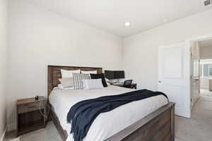 Bedroom with light carpet and recessed lighting