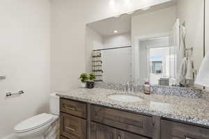 Bathroom with curtained shower and vanity