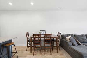 Dining room featuring light wood-style floors and recessed lighting