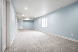 Basement featuring light carpet and recessed lighting