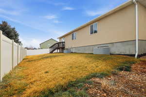 Rear view of property with a fenced backyard and stucco siding
