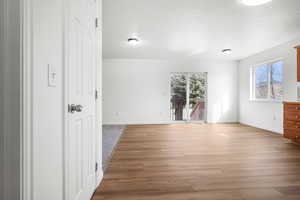 Empty room with light wood-style flooring and a textured ceiling