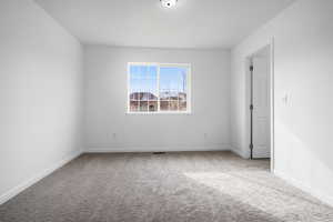 Carpeted empty room with baseboards