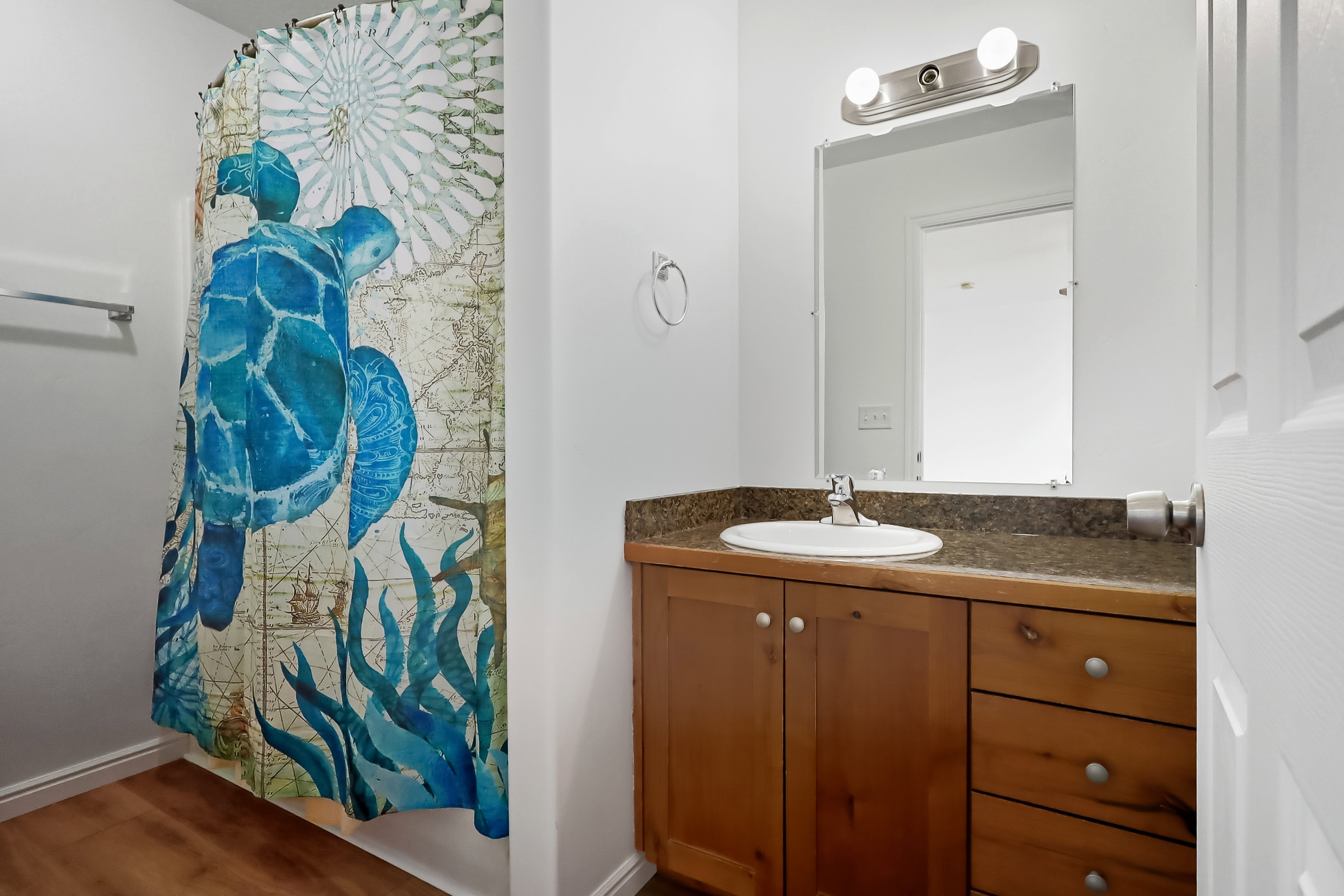 Full bathroom featuring curtained shower and vanity