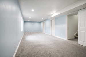 Finished below grade area with carpet floors and recessed lighting
