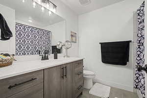 Full bathroom with vanity, and light tile patterned floors