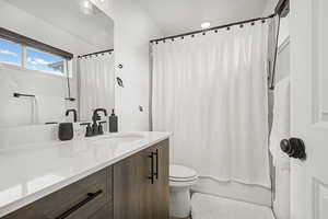 Full bathroom featuring vanity and shower / tub combo with curtain