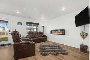 Living area with wood finished floors, and recessed lighting