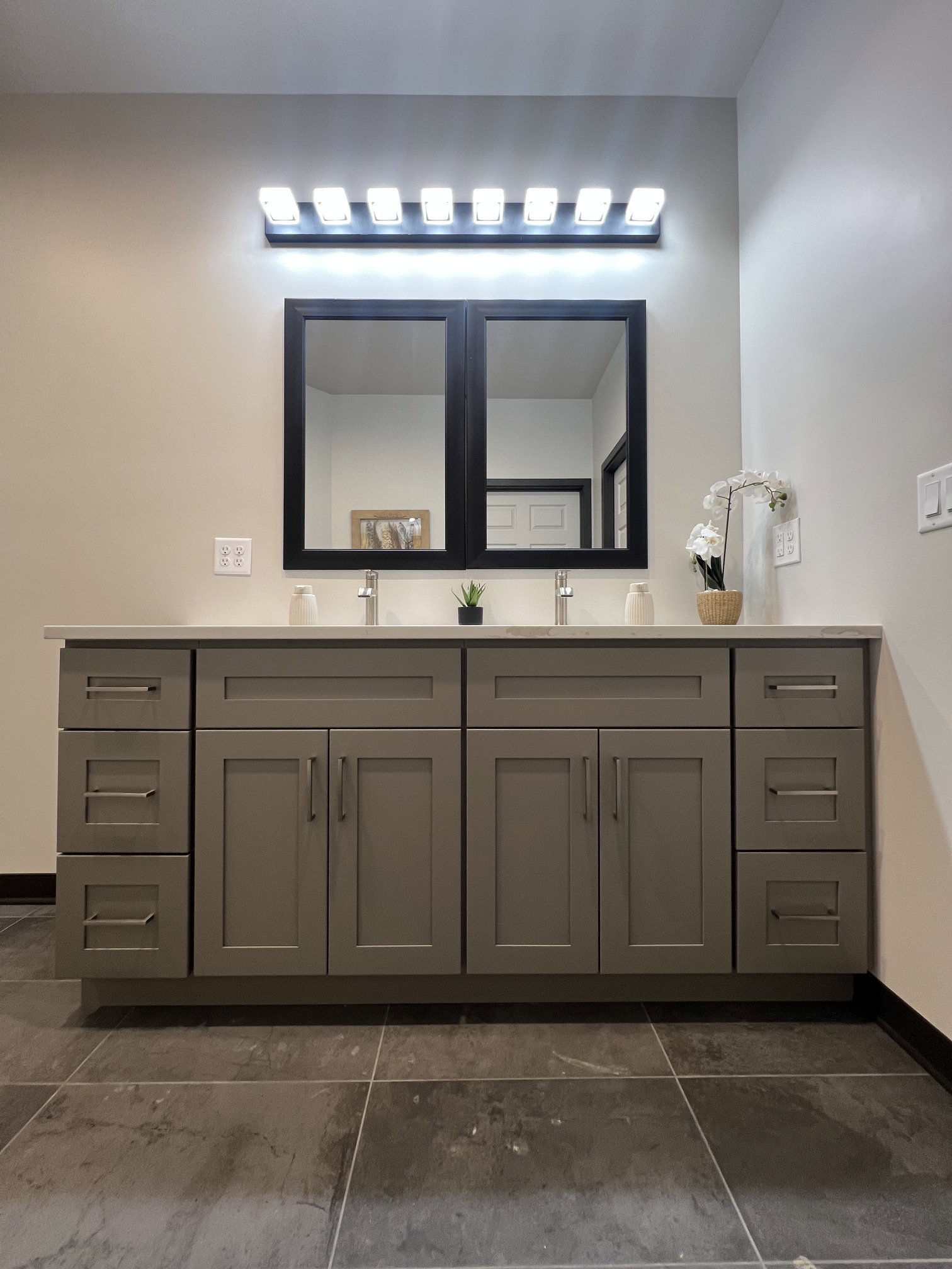 Dual vanity with light gray shaker cabinetry, brushed nickel hardware, and a white countertop