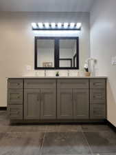 Dual vanity with light gray shaker cabinetry, brushed nickel hardware, and a white countertop