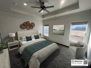 Carpeted bedroom with a ceiling fan, recessed lighting, and a raised ceiling