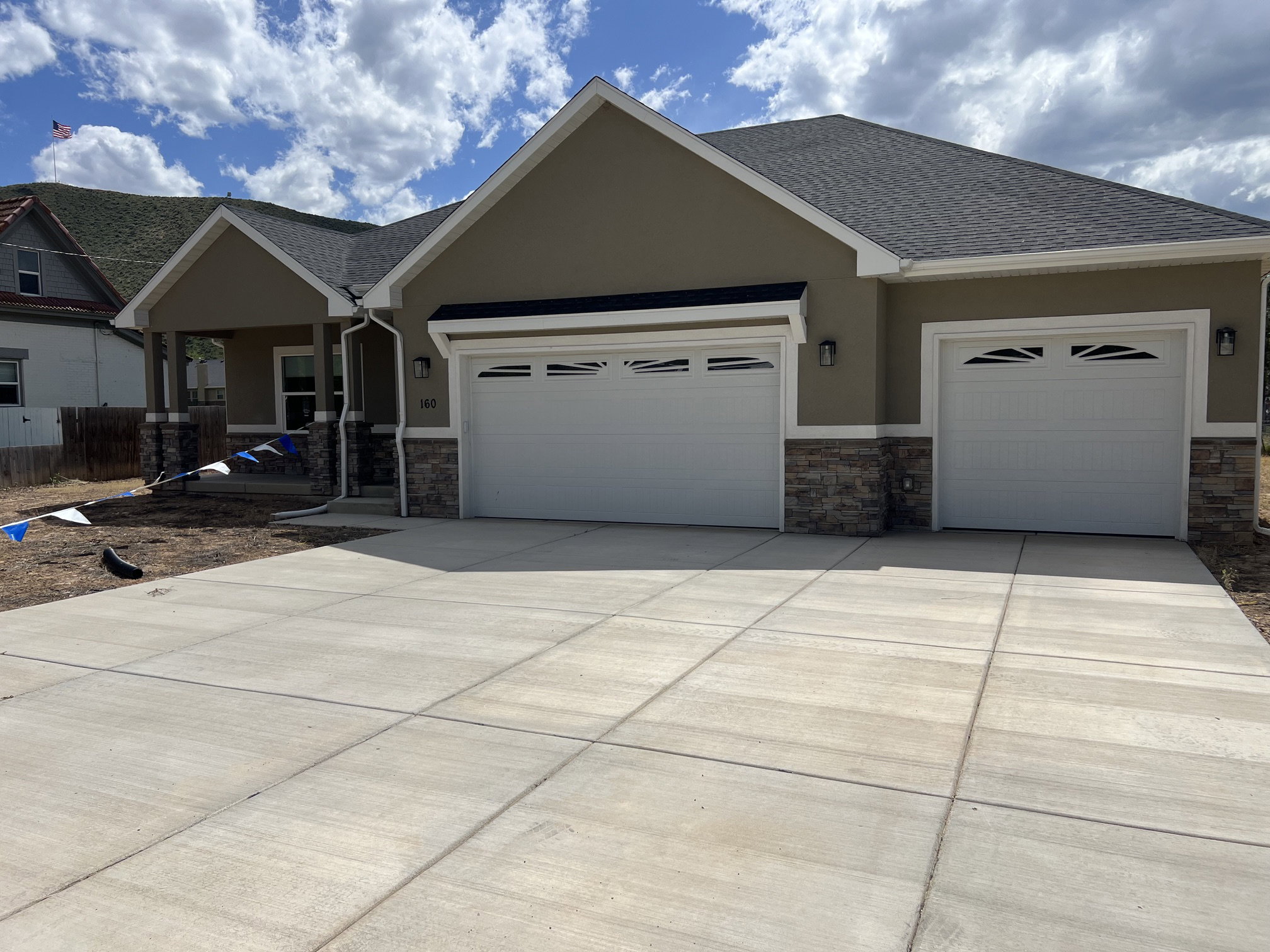 Contemporary stucco exterior with a stone veneer accent