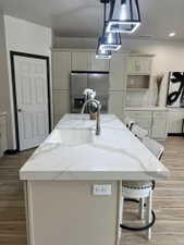 Kitchen island featuring a white countertop with grey veining and an integrated sink