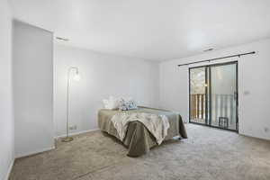 Bedroom with carpet flooring and access to outside