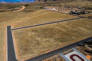 Aerial view of sparsely populated area featuring a mountainous background and a desert landscape