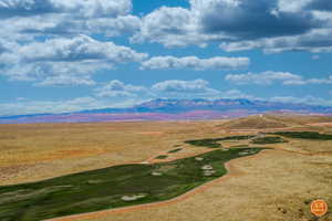 Aerial view of a mountainous background and a golf course