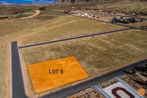 Aerial view of sparsely populated area featuring a mountain backdrop and a desert landscape