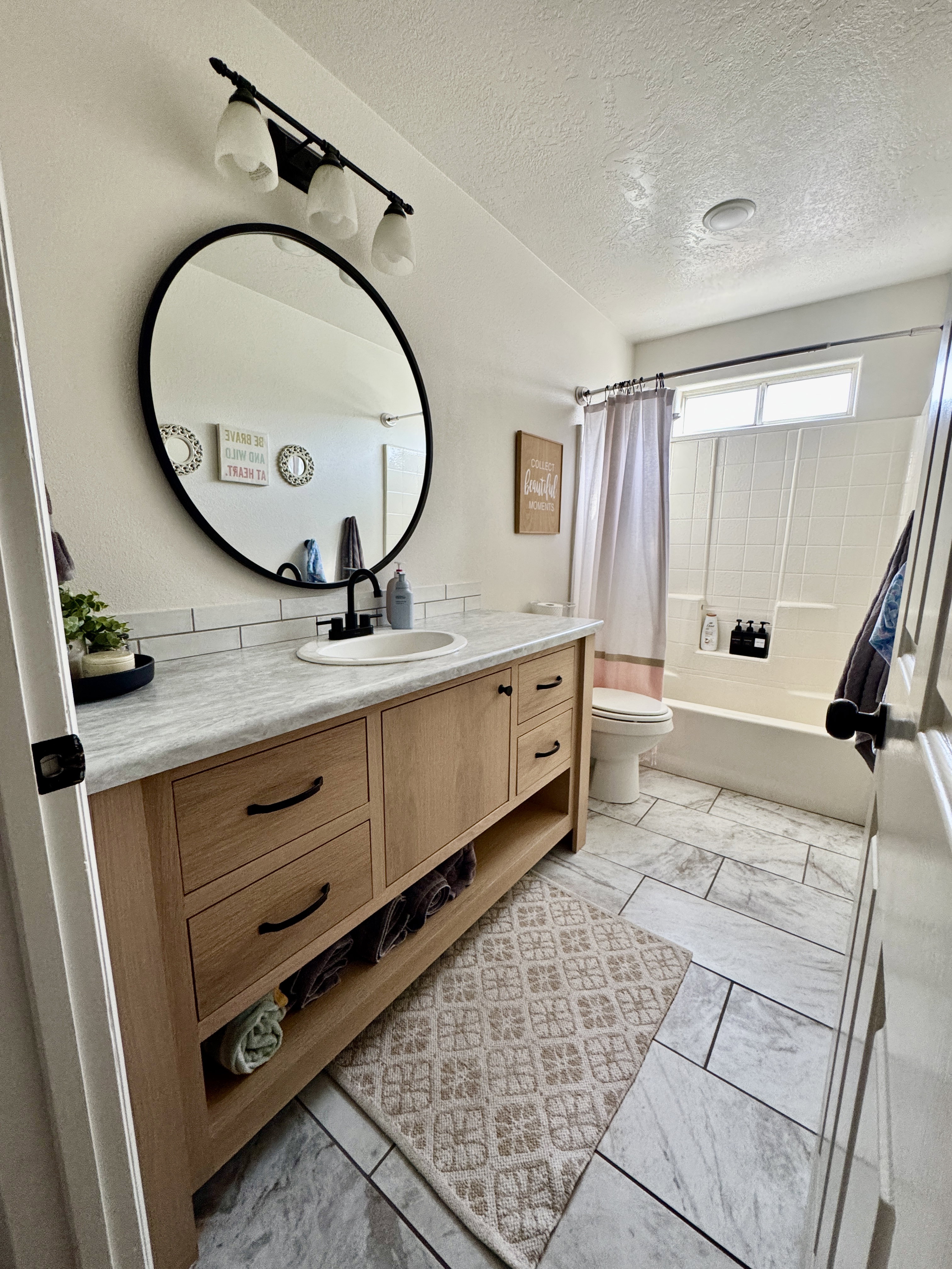 Full bath featuring vanity, shower / tub combo, and a textured ceiling